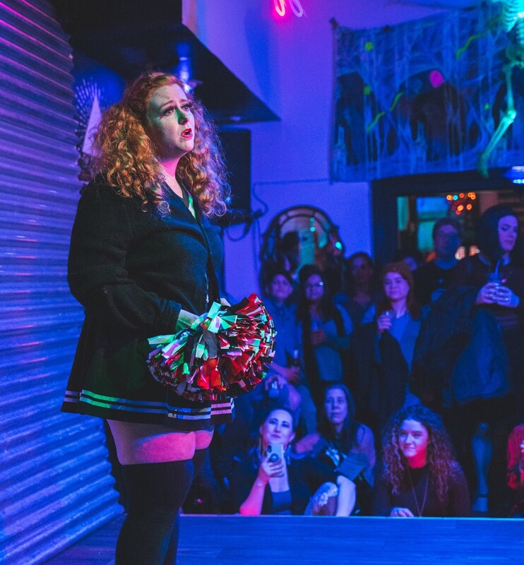 Amy Rudnik performing as sad cheerleader. Mixwells Northside. November 2019.